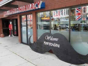 Roulston's drug store in downtown Simcoe is promoting the upcoming Mumford & Sons Gentlemen of the Road Stopover with a giant moustache in front of the store. The display is part of a contest involving downtown businesses.  (KIM NOVAK Simcoe Reformer)