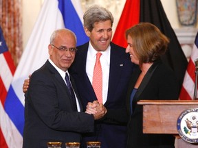 Chief Palestinian negotiator Saeb Erekat, U.S. Secretary of State John Kerry and Israeli Justice Minister Tzipi Livni shake hands last month, as peace talks between the two sides resumed.