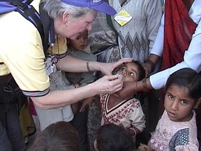 Rotarian Adrienne Brown of KIngston administers polio vaccine to children in India during a visit in 2004.
Submitted Photo