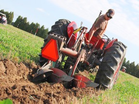 Eric Prelaz, 17, expertly operates his two-furrow semi-mounted plow during this year's Chatham-Kent Plowing Match on Maynard Line, on Saturday August 10, 2013. Perlaz has been participating in plowing competitions for the last 7 years and was one of around 40 competitors to compete at the local level. KIRK DICKINSON/FOR CHATHAM DAILY NEWS/ QMI AGENCY