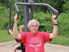 Tom Feindel tries out the exercise equipment at the Krista Johnson Fitness Grove, located in the east end of Riverside Park. A free demonstration of how the different gear is to be used will be held Aug, 13, starting at 6 p.m.