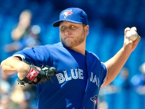 Blue Jays starting pitcher Mark Buehrle throws against the Athletics in the first inning at the Rogers Centre yesterday.  (REUTERS/Fred Thornhill)