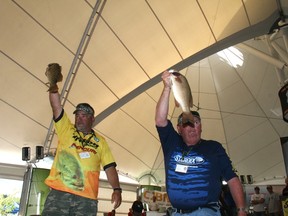 First place team Leroy Wilson and Bill Godin raise fish from their five smallmouth catch during Saturday’s Top 10 boat parade, Aug. 10, 2013.