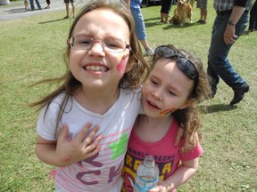 Angelyna Forlini, 7, and her sister Aryana, show off their painted cheeks while wandering the Williamstown fairgrounds with their parents on Saturday, Aug. 10.

CHERYL BRINK/CORNWALL STANDARD-FREEHOLDER/QMI AGENCY
