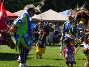 Bill Mandawoub, left, shows his 20-month-old daughter Mya some dance steps Saturday afternoon during the 42nd annual competition powwow at the James Mason Cultural Centre at Saugeen First Nation. (DENIS LANGLOIS)
