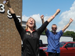 Jessica VandenBussche, 24, of Turkey Point (left) recently cycled across Ontario to promote the benefits of exercise for those with mental health issues. She asked people to to take a minute to do a yoga pose and set a physical activity goal during a celebration of her accomplishments at the Canadian Mental Health Association's Simcoe office. With her is Michael Benin, executive director of the Haldimand-Norfolk branch of CMHA. (SARAH DOKTOR Simcoe Reformer)