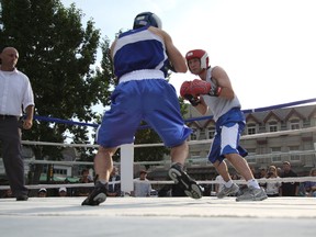 Roy Leonard, right, of the Canmore Fight Club squares off against Nick Yee of Grand Prairie in a junior middleweight bout at the K.O. Cancer amateur boxing card in Banff on Saturday, Aug. 10, 2013. The event raised more than $4,000. Russ Ullyot/ Crag & Canyon/ QMI Agency