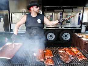 Ribber Josh Vanham of Ribs Royale barbecues some ribs at the Quinte Ribfest earlier this year. Ribs Royale will be in Kington starting Friday for the first Kingston Ribfest and Craft Beer Show. 
  JEROME LESSARD/The Intelligencer/QMI Agency