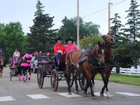 Valleyview couple Larry and Ena Clegg lead the parade as the Wild Pink Yonder riders trot into Wembley, Sunday. The 23-day, 22-town trail ride-fundraiser rakes in cash for the Alberta Cancer Foundation and has raised nearly $500,000 over five years. It will cover more than 500 kilometres across the Peace Country by the time tours wrap up on Sept. 1. (Elizabeth McSheffrey/Daily Herald-Tribune)