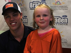 Aly Davis, 4 poses for photographs with NHL star Taylor Hall at the Invista Centre Sunday. A hockey camp with the hockey player raised more than $28,000 for the Children’s Cancer Fund of Kingston. (Danielle VandenBrink The Whig-Standard)