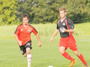 Simcoe Thunder's Steve Parker chases after the ball following by a Middlesex player during a game at the Norfolk Youth Soccer Field on Sunday. Simcoe lost 2-1. (SARAH DOKTOR Simcoe Reformer)