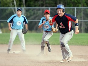 The Jays' Alex Hurley, middle, tries to run down the Cardinals' Jacob Brown, right, Sunday during the North Bay Baseball Association bantam division championship at Steve Omischl Sports Field Complex. Brown was safe but the Jays, thanks to Hurley's game-winning RBI single in the bottom of the sixth inning, won 5-4. JORDAN ERCIT/The Nugget