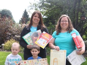 KEVIN RUSHWORTH HIGH RIVER TIMES/QMI AGENCY. Spitzee Elementary School teachers Cathy King, at back left, and Janet Jack, back right, are co-ordinating a teachers resource drive for those educators who lost their teaching materials in the flood. The two were joined by Kaiden Seeley, front left, and Vance King who were both excellent at helping to hold some of the teachers resources.