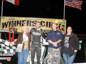 Andrew Reaume, second from left, celebrates winning the first Gord DeWael memorial race Saturday at South Buxton Raceway with, from left, DeWael's wife Judy, son Jeff and daughter Jen. (JAMES MACDONALD/Special to The Daily News)