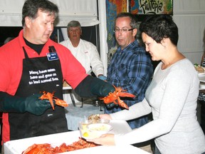 Kenora Kinsmen Mike Aiken serves lobster at the first-ever Lobsterfest to be held at the Whitecap Pavillion in 2012. The Rotary Club of Kenora event has been a popular social event in Kenora for 17 years and returns Saturday, Aug. 24 with great food and dance music by Fat City.
FILE PHOTO/Daily Miner and News
