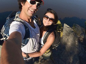 Roberto Gomez, left, and wife Bella, right, take a photo on top of Devil’s Rock, New Liskeard, Ontario. The pair make up the Expeditioners, traveling around the world while blogging and Facebooking about their adventures. They are currently traveling across-Canada and stopped in Kenora on Friday, Aug. 9. 
SUPPLIED PHOTO/Daily Miner and News