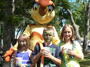 The Summer in the Park mascot will get a name next week, organizers say. A contest was held during this year's event and the selection will be made by the festival committee. The Summer in the Park mascot was seen throughout the festival grounds this year. Here, Macy Mothersill (left) poses with her friends KJ and Matsyn Ferreira and the mascot.