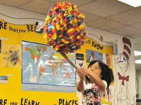 Brielle Ariey, 7, tries to break open a pinata during the Mayerthorpe Public Library’s Summer Reading Program on Tuesday, Aug. 6.