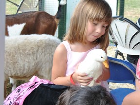 Marisa Schultz, 5, gets to hold a duck as part of Rochfort Bridge’s Heritage Day petting zoo on Monday, Aug. 5. Schultz and her family are from Grimshaw, Alta. They were just travelling by on their holiday when they saw the sign for Heritage Day on the highway and decided to check it out.