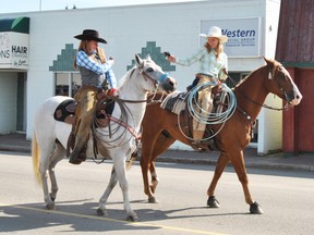 Brianna Grienkie and Thea Johner ride horses during the 58th annual Mayerthorpe Agricultural Fair Parade on Aug. 10, 2013. The parade is taking place yet again during the upcoming Agricultural Fair on Aug. 12, but the fair’s organizing society is making adjustments to other events (File photo | Mayerthorpe Freelancer).