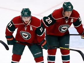 Minnesota Wild left wing Zach Parise (11) and defenceman Ryan Suter (20) prepare for a puck drop during the third period of their NHL hockey game against the Colorado Avalanche in St. Paul, Minnesota January 19, 2013. (REUTERS)