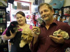 Melissa Laing, left, and Walter Palubiskie of Parrots and Poodles pet store on Third Avenue show off just some of the cool creatures that will be hanging out downtown as part of Friday’s Urban Park festivities.