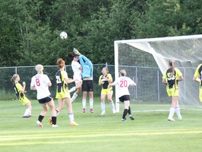 Gold Diggers' netminder Kaitlin Sparkman punches away a Taggs' corner kick before colliding with Beth Pernsky in Monday night's Kenora Women's Soccer League semifinal.
LLOYD MACK/Daily Miner and News