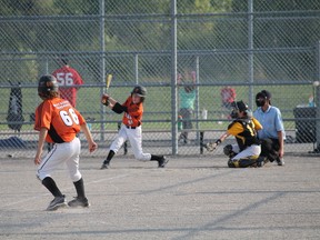 Alex Rayner of the Paris Phillies looks to steal home with Austin Rhodes up to bat during a game against the Waterloo Tigers at Green Lane Sports Complex in Paris on Wednesday, Aug. 7. The Phillies won 16-4. MICHAEL PEELING/The Paris Star/QMI Agency