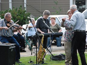 Revelers took to the grass to spin and twirl as a band played music for residents of Caskey Place on Tuesday, August 6.