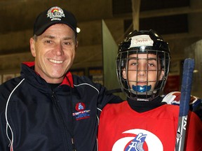 Hockey Ministries International hockey school co-ordinator and HHN Honoured Member Brent Tremblay poses with one of the camp’s participants, Justin Pellerin, from North Bay.
