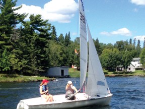 Lisle Compton, left, and Krista Robertson, right, sail past Coney Island after slipping through Cameron Point during the Royal Lake of the Woods Yacht Club Kenora Cup. Compton was one of a few sailors honoured at the 2013 Sailing Awards. 
SUPPLIED PHOTO