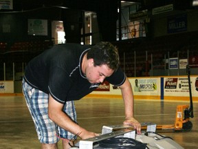 Chris Leslie of Straight Street Event Services in Kitchener assembles new speakers being installed at the Harry Lumley Bayshore Community Centre this week. The new sound system is part of renovations by the Attack hockey team. Tracey Richardson photo.