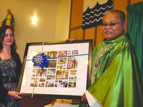 Rebecca Sakowich presents Father Hamilar Blanco with a card signed by parishioners of St. Dominic’s and Assumption Catholic parishes. Theresa Seraphim/Cold Lake Sun