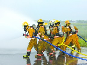 Members of Cold Lake Fire Rescue inch towards a “phalange” during a recent industrial firefighting exercise.Theresa Seraphim/Cold Lake Sun