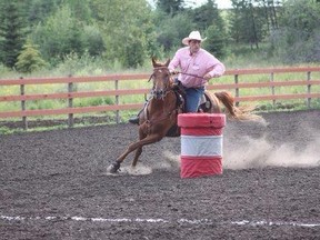 Melvin Underwood WSAGC (Vice-president) rounding the barrels on his horse “Red”.