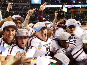 Texas A&M quarterback Johnny Manziel (middle) celebrates with teammates following their victory over the University of Oklahoma in the Cotton Bowl game at Cowboys Stadium in Arlington, Texas January 4, 2013. (REUTERS/Mike Stone)