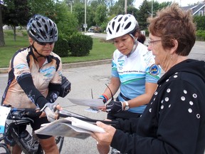 Marion Prins, right, a summer resident at Erieau, Ont. welcomes cyclists Mary-Ann Kruse, left, of Oakville, Ont., and Lesley Woo, of Toronto, Ont., during a lunch stop at the Lake Erie-side resort community, Tuesday, Aug. 13, 2013. Erieau is part of the Great Waterfront Trail Tour.
BOB BOUGHNER/ THE CHATHAM DAILY NEWS/ QMI AGENCY