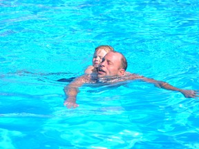 Mike Bult and his daughter, April, 4, spend the afternoon of Tuesday, Aug. 6,º swimming at the Mayerthorpe Aquatic Centre.