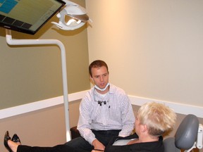 Dentist Dr. Todd McClenaghan (left) chats with receptionist Lee Wrigley as she tries out the massaging dental chair, one of the many unique features to McClenaghan’s new dental office, South 40 Dental, located at the South 40 Shopping centre. (Jocelyn Turner/Daily Herald-Tribune)