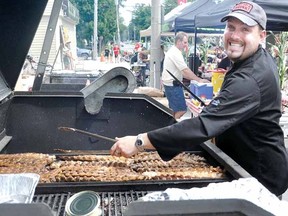Mitchell's Ben Uniac cooks ribs at last year's Mitchell and District Kinsmen's Cornfest/Ribfest. The 36th annual version of the event returns this weekend. (ANDY BADER QMI Agency)
