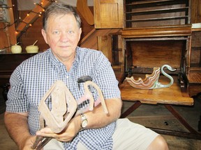 Bill Humphrey, owner of the Jarvis Antiques & Collectibles Market, is looking forward to a busy Cornfest this weekend. Humphrey is displaying a pair of old branding irons that he purchased on a recent picking mission out west. (MONTE SONNENBERG Times-Reformer)