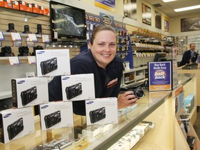 Jacqueline Bloye, store manager of Henry's in Sudbury, ON., shows some of the 10 cameras that will be shipped to Attawapiskat with memory cards, a printer and printing supplies. The equipment and supplies are being donated to Attawapiskat for Journalists for Human Rights Northern Ontario Initiative project. JOHN LAPPA/THE SUDBURY STAR/QMI AGENCY