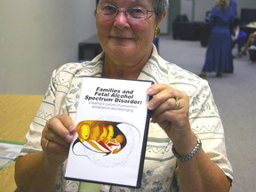 Ethel de la Penotiere holds a copy of a new DVD developed in London as a resource for families and professionals dealing with Fetal Alcohol Spectrum Disorders.