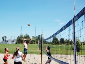 Gareth Martin, of Suns Out Guns Out, goes for a hit in a game of mixed beach volleyball this weekend. Also in the photo is Jenna Yaraskavich (left) and Erica Lapierre (centre).