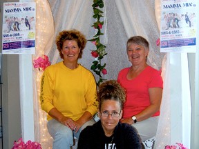 Wanda Lauren (left), Sherry Hilton (centre), and Sue Packer sit beneath a makeshift wedding booth within River City Cinemas in Peace River. The theatre will host a special one night only screening of the film on August 24 in support of the St. James' Cathedral. DANIELE ALCINII/QMI AGENCY