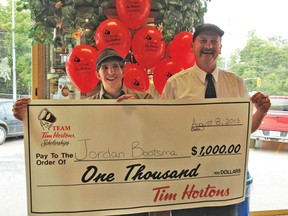 Randy Salverda, owner of the Tillsonburg Tim Hortons restaurants, presents Jordan Bootsma with a $1,000 Team Tim Hortons Scholarship at the Tim Hortons on Oxford Street. CONTRIBUTED PHOTO