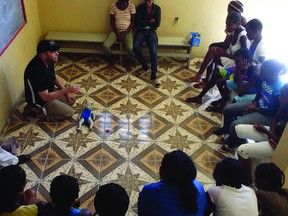 Aaron Sousa demonstrates infant CPR in the Help Tammy Help Haiti clinic in Cité Soleil to new and expecting mothers.