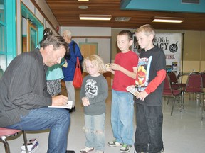 Author Sigmond Brouwer signs autographs for Boyd, 6, Brodie, 9, and Broc Gaffney after the wrapup session of the Whitecourt and District Public Library’s children’s reading program.
Barry Kerton | Whitecourt Star