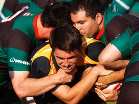 Bow Valley Grizzlies scrum-half Ian Tivendale  is gang tackled by Saracen players during game at Grizzly Den, Aug 9.