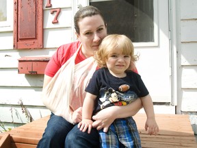 Tara Hall sits on her stoop with her two-year-old son Austin. Hall was crossing Saskatchewan Avenue on Tuesday when she and her son were hit by a distracted driver. (Svjetlana Mlinarevic/Portage Daily Graphic/QMi Agency)